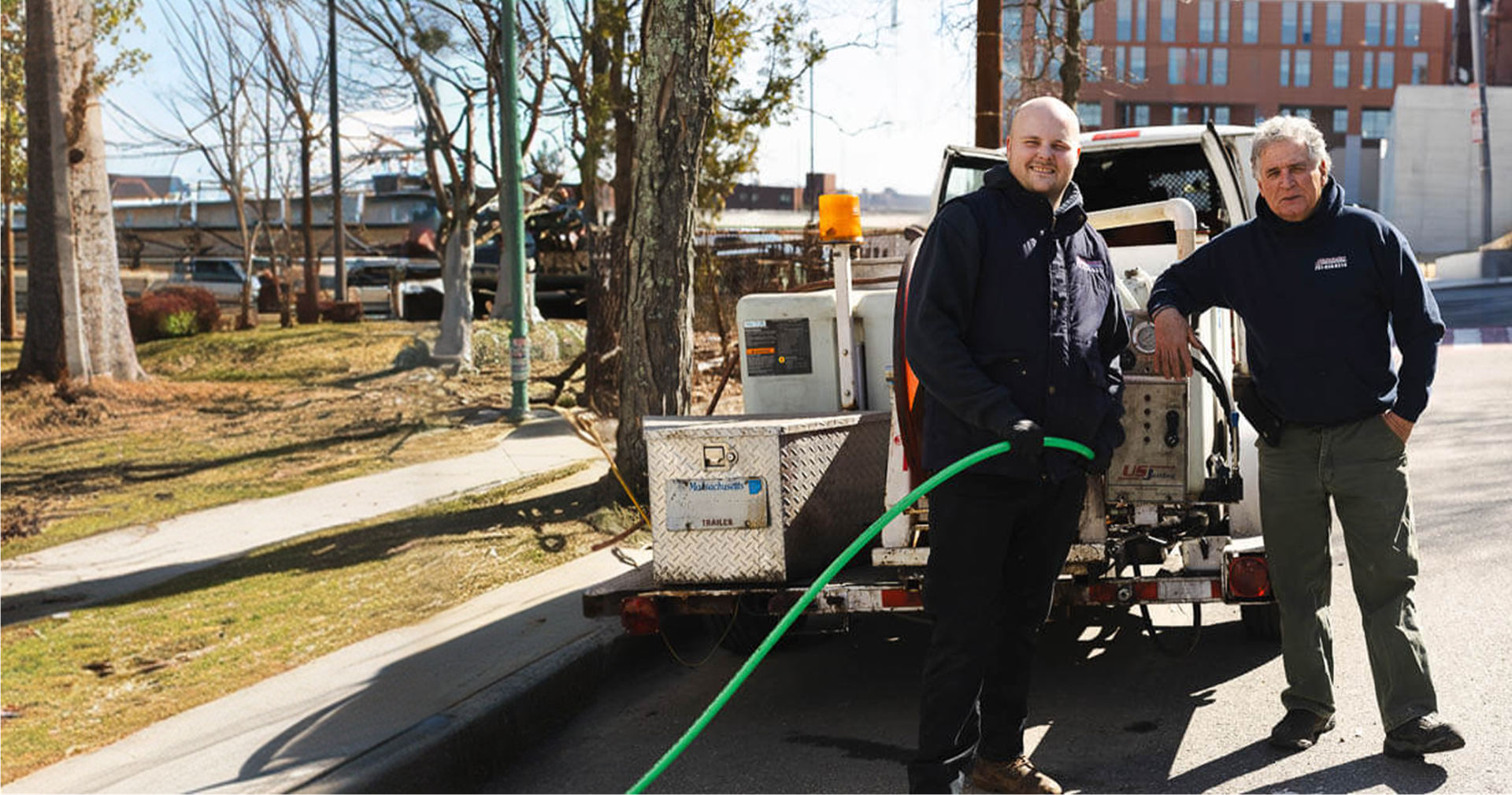 Snake-It-Away team with their service vehicle in Boston